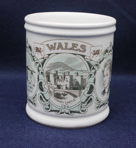 White mug with 'Wales' and a castle design on a blue background