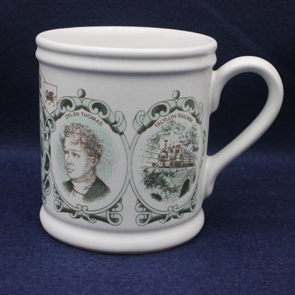White mug with decorative elements including a portrait and text on a blue background