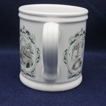 White mug with decorative brown designs on a blue background