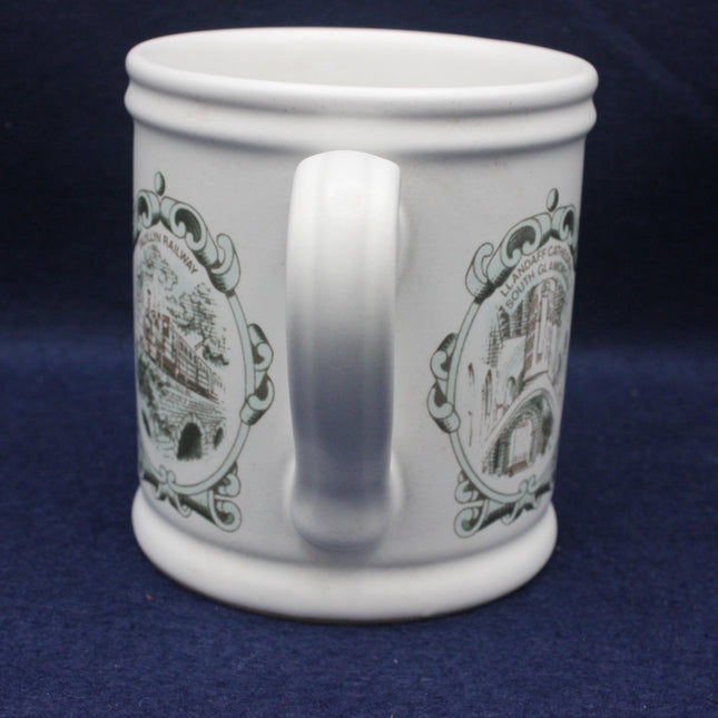 White mug with decorative brown designs on a blue background