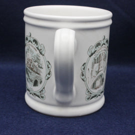 White mug with decorative brown designs on a blue background