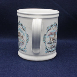 White mug with decorative blue and brown patterns on a dark blue background