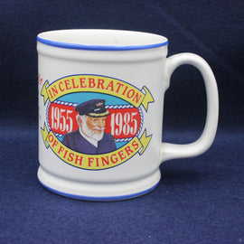 White mug with colorful design celebrating fish fingers from 1955 to 1985 on a blue background