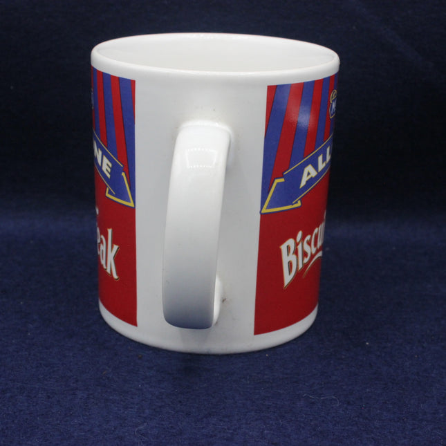 White mug with red and blue striped design on a dark blue background