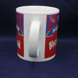 White mug with red and blue striped design on a dark blue background