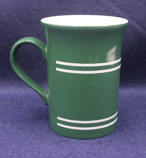 Green mug with white stripes on a purple background