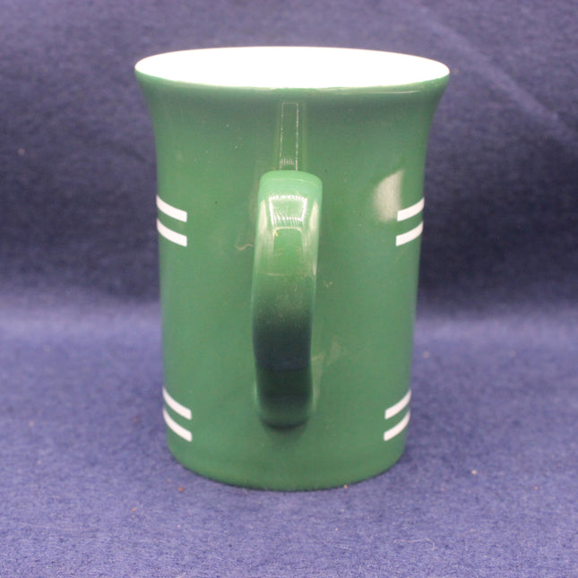 Green mug with white stripes on a blue background