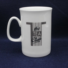 White mug with 'the TEA Club' text on a dark blue background