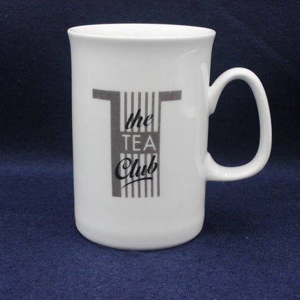 White mug with 'the TEA Club' design on a blue background