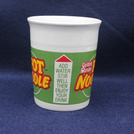 White cup with a colorful label on a blue background