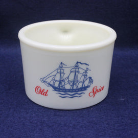White cup with blue ship design and 'Old Spice' text on a dark blue background