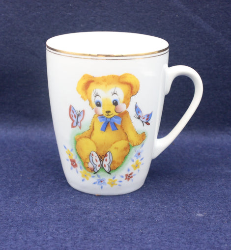 White mug with a teddy bear design on a blue background
