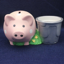 Pink piggy bank with a gray cup on a blue background