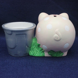 Pink piggy bank with white polka dots and green feet on a blue background