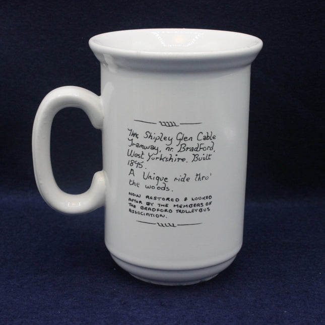 White mug with black text on a dark blue background