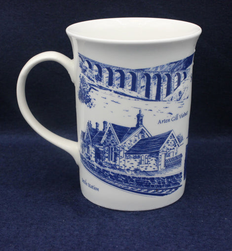 White mug with blue architectural design on a dark blue background