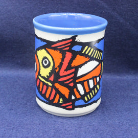 Ceramic cup with a colorful fish design on a blue background
