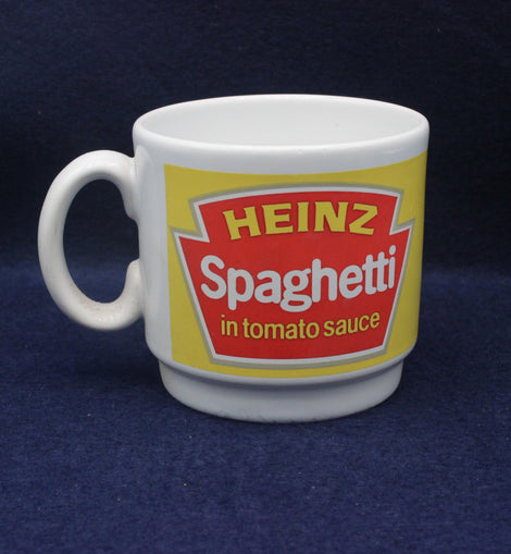 White mug with Heinz Spaghetti in tomato sauce label on a dark blue background