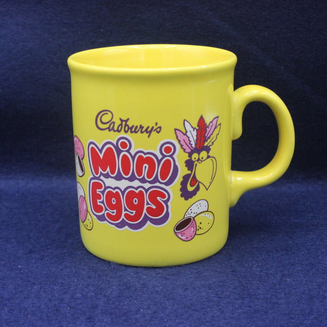 Yellow mug with Cadbury's Mini Eggs branding on a blue background