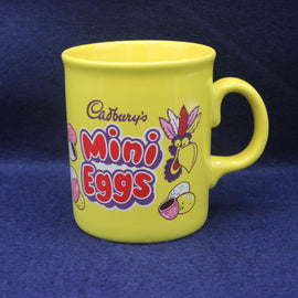 Yellow mug with Cadbury's Mini Eggs branding on a blue background
