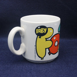 White mug with cartoon characters and 'BABY' text on a dark blue background