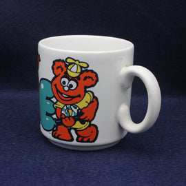 White mug with a colorful cartoon character Fonz on a dark blue background