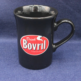 Black mug with Bovril logo on a blue background
