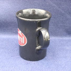 Black mug with a red logo on a blue textured background