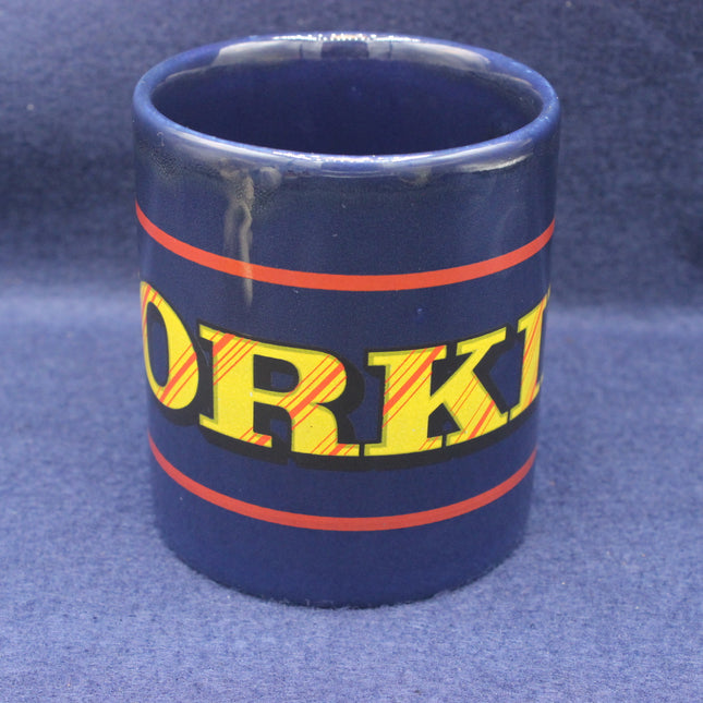 Blue mug with 'YORKIE' text on a blue background