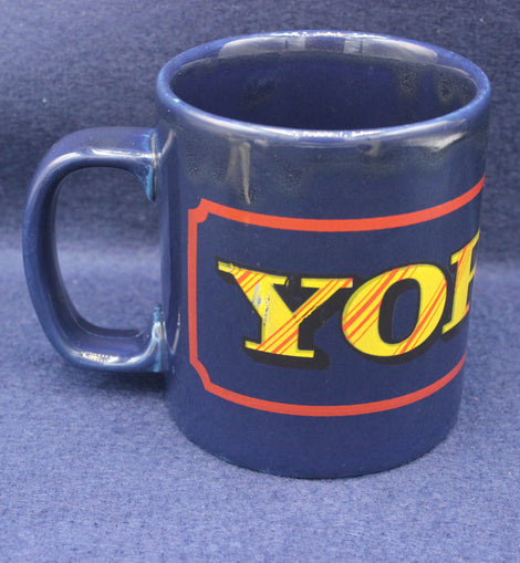Blue mug with 'YORKIE' text on a blue background