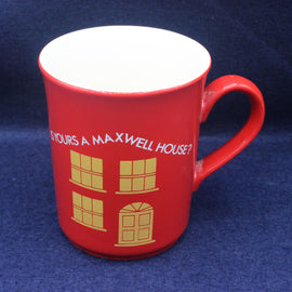 Red mug with white maxwell House text and design on a blue background