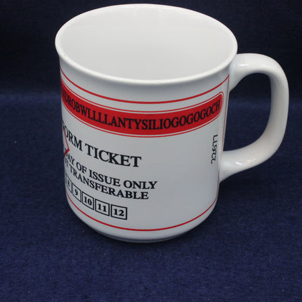 White mug with red and black text on a dark blue background