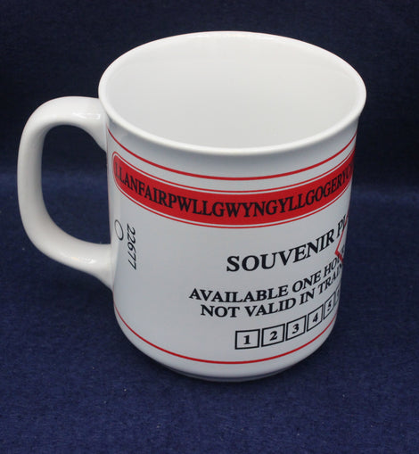 White souvenir ticket mug with red and black text on a blue background