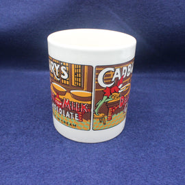 White mug with colorful graphics and text on a blue background