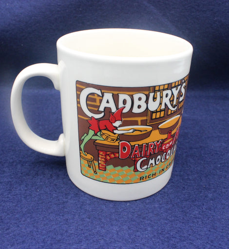 White mug with Cadbury Dairy Milk Chocolate branding on a blue background