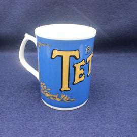 Blue mug with gold lettering on a blue background