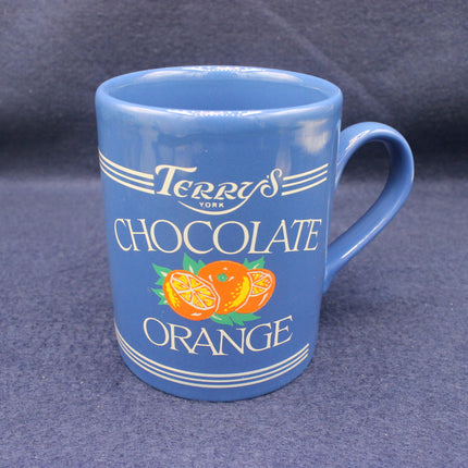Blue mug with Terry's Chocolate Orange branding on a dark gray background