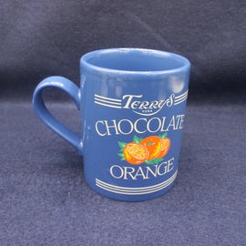 Blue mug with 'Terry's Chocolate Orange' branding on a dark background