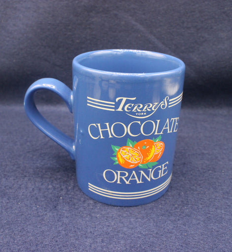Blue mug with 'Terry's Chocolate Orange' branding on a dark background