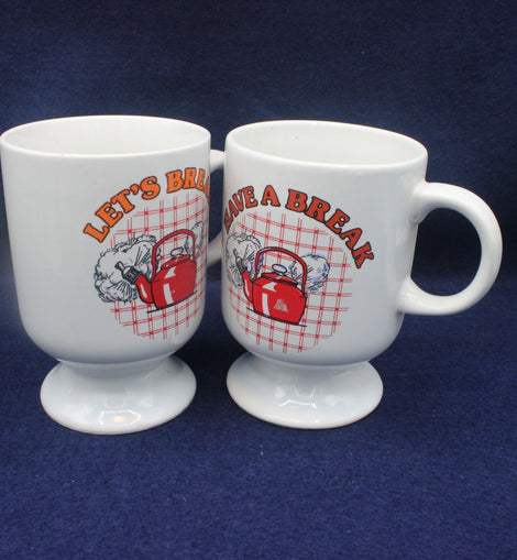Two white mugs with red and orange graphics and text on a blue background