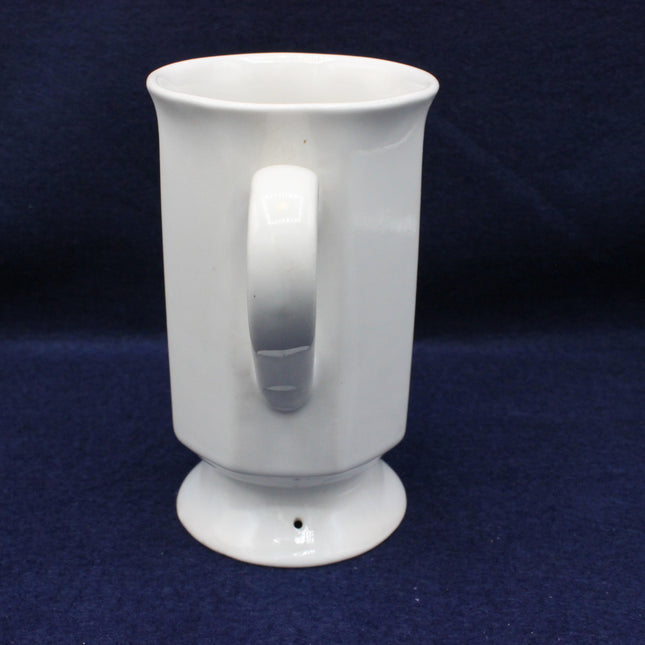 White ceramic mug with a handle on a dark blue background