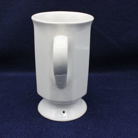 White ceramic mug with a handle on a dark blue background