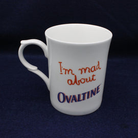 White mug with 'I'm mad about Ovaltine' text on a dark background