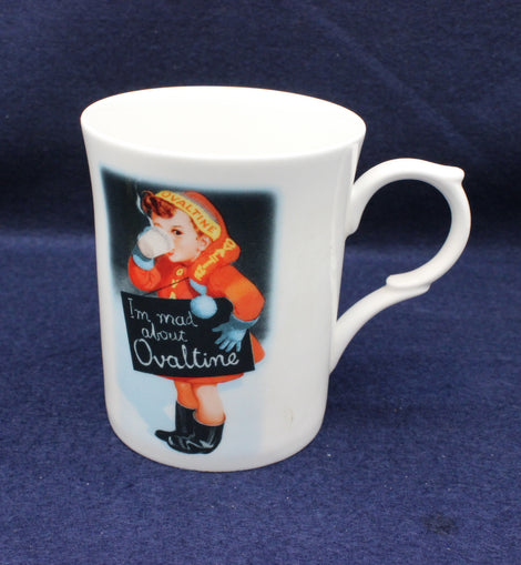 White mug with vintage illustration of a child and 'I'm mad about Ovaltine' text on a blue background