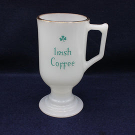 White mug with 'Irish Coffee' text and shamrock on a dark background