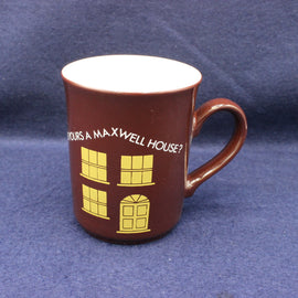Brown mug with yellow text and house design on a blue background