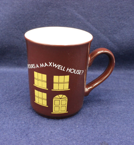 Brown mug with yellow text and house design on a blue background