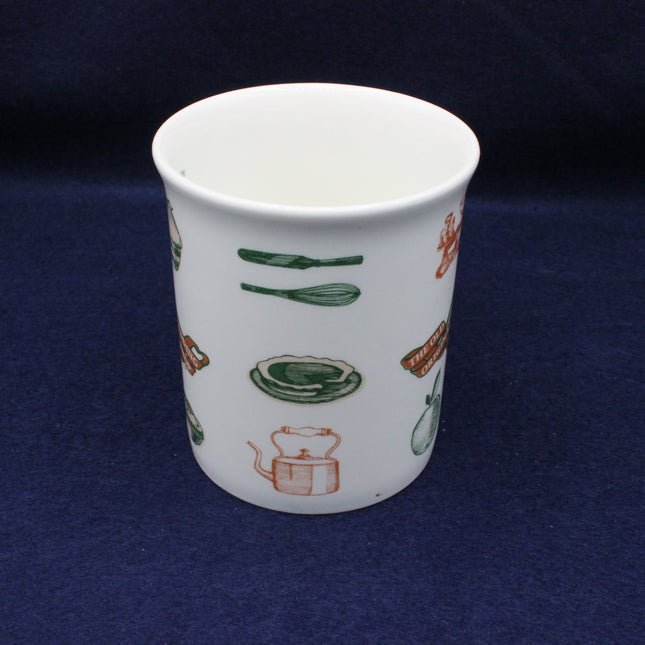 White ceramic cup with colorful illustrations on a dark blue background
