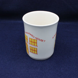 White paper cup with red and yellow design on a blue background