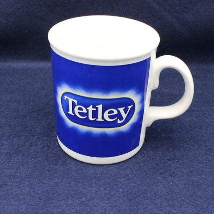 Blue mug with 'Tetley' logo on a dark blue background
